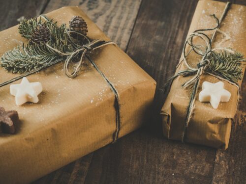 Photo of Two Brown Wrapped Gifts on Wooden Table